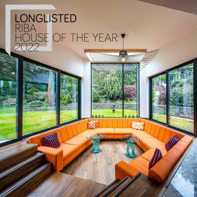 Sunken sofa in living space. Longlisted RIBA House of the Year 2022 logo in the top left hand corner.